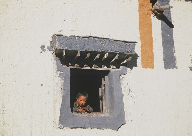 tibetan boy staring from window